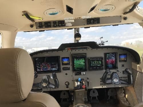 The cockpit of the aircraft features a modern instrument panel with multiple displays.