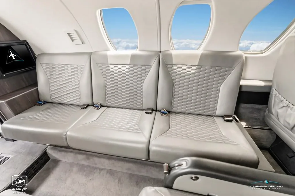 A close-up of the grey quilted leather seating in the cabin of the N15JT Cessna Citation X.