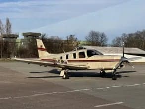 A Piper PA-28-181 Archer II, registration D-EJMW, parked on the tarmac.