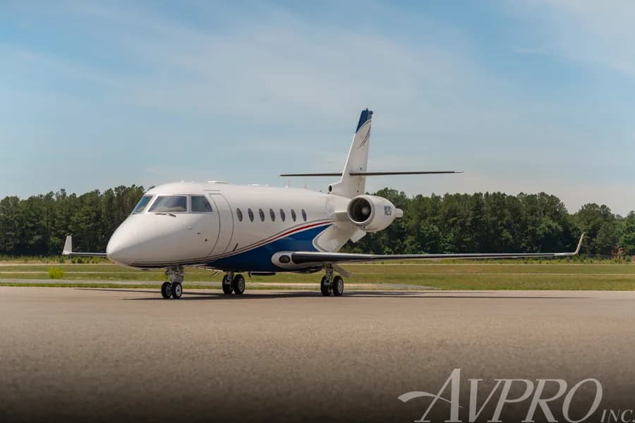 A Gulfstream G200 business jet, tail number N2G, parked on a tarmac on a clear day.