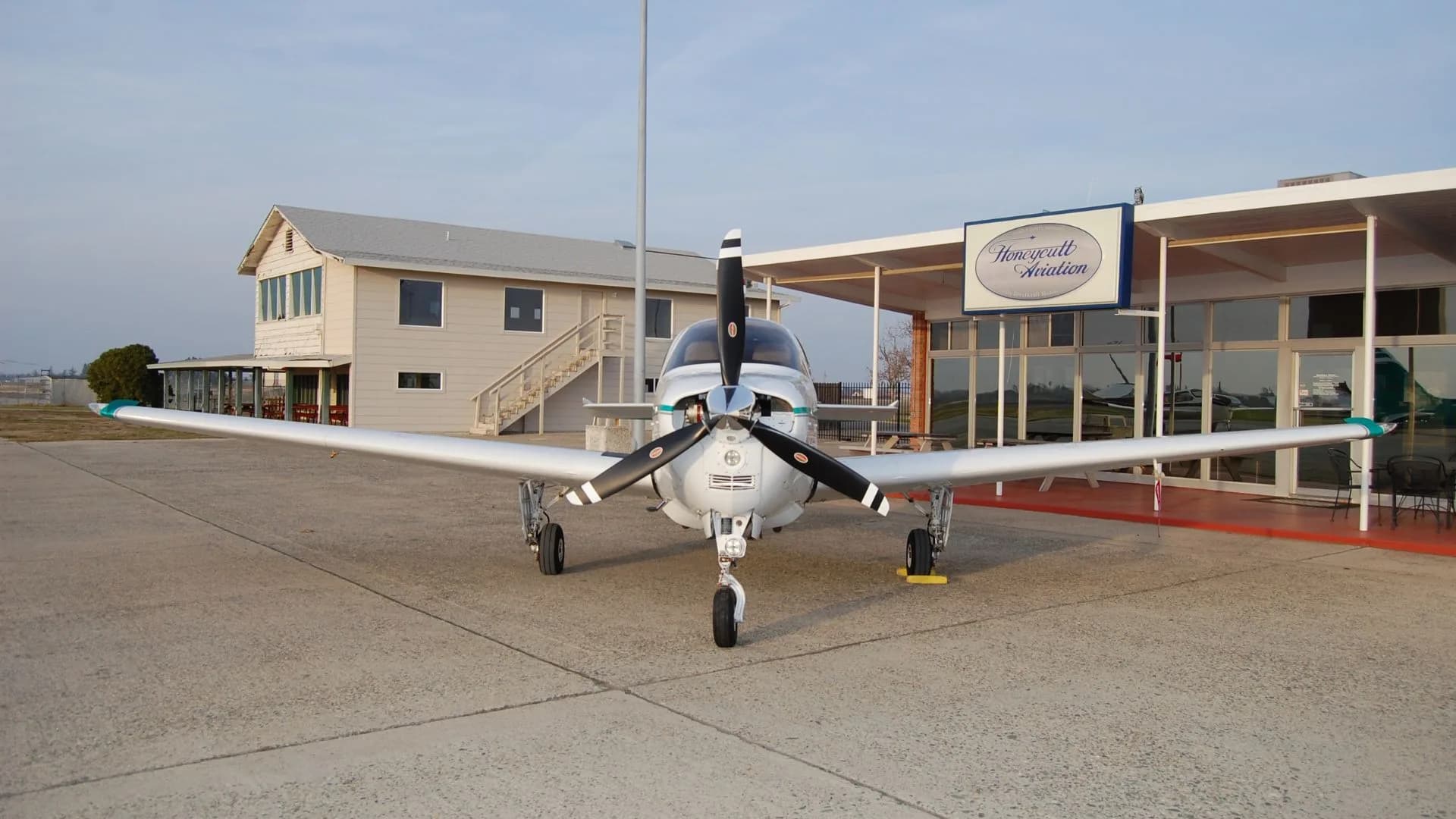 Front view of the Beechcraft Bonanza N54DG on the tarmac in front of Honeycutt Aviation.