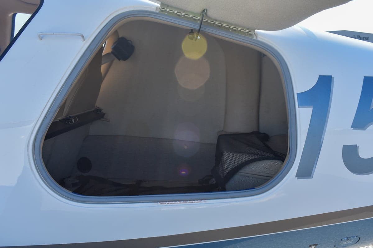 View of the aircraft's interior with tan leather seats and side panel.