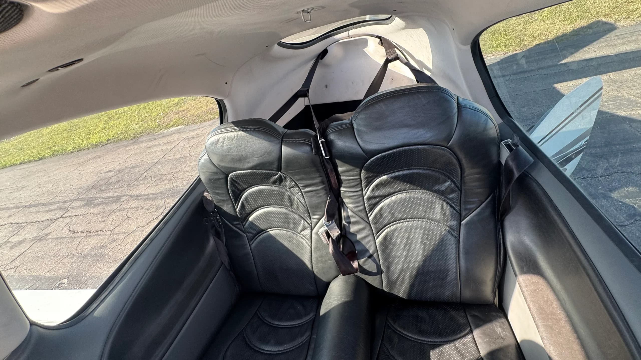 A view of the two black leather rear seats in the cabin of the Cirrus SR22T.