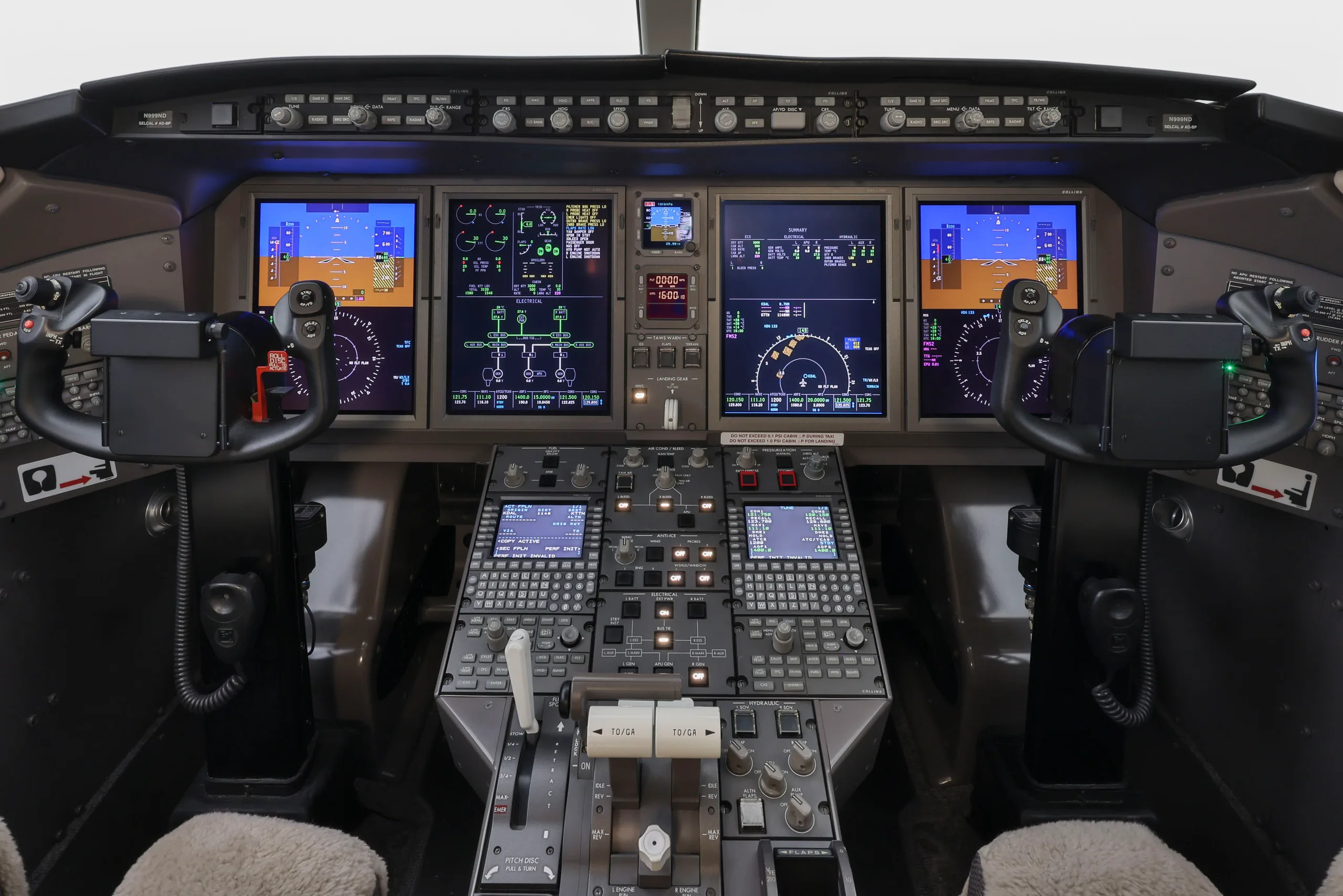 The modern cockpit of a business jet with multiple digital displays, control yokes, and a central throttle quadrant.