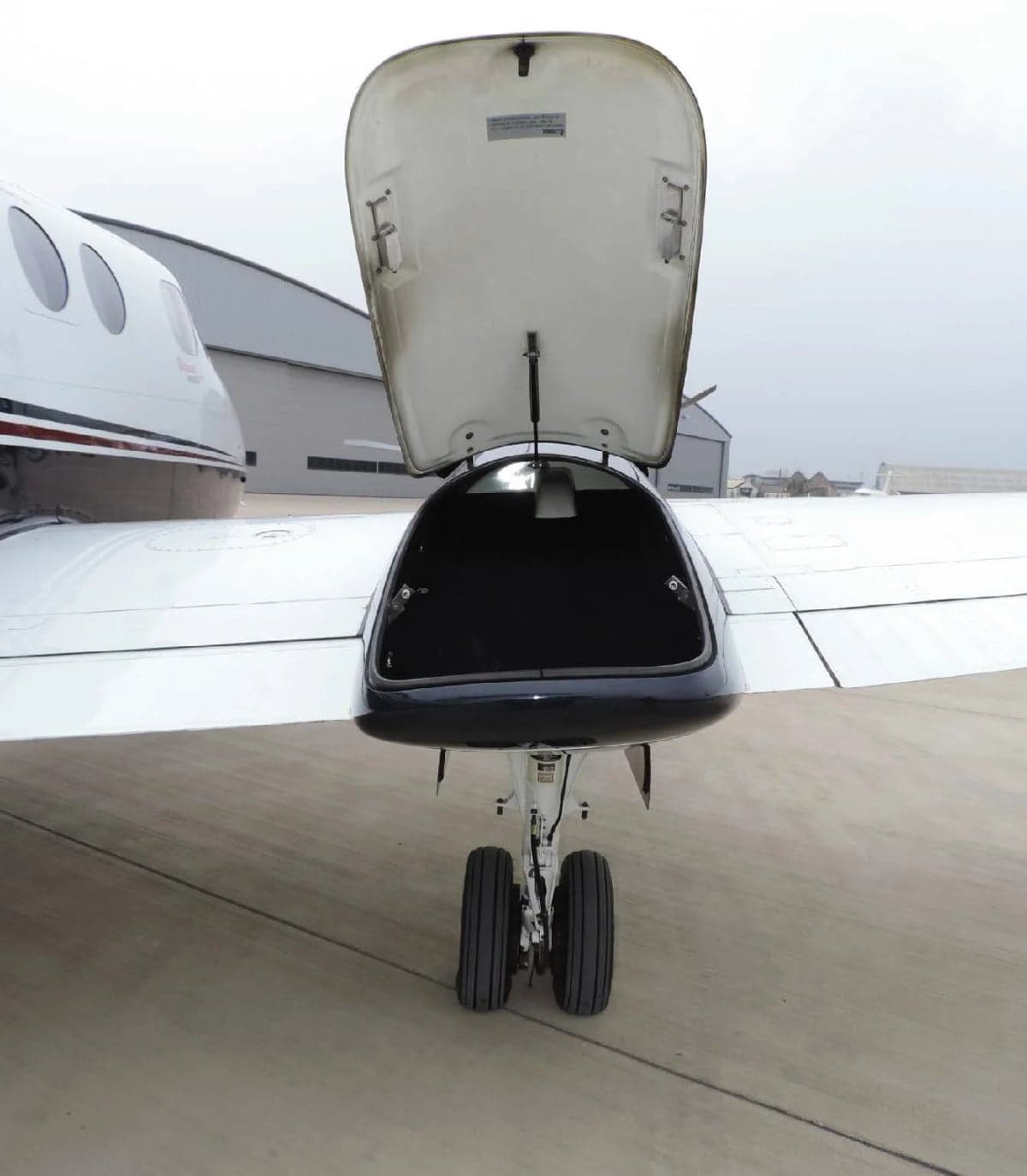 Nose baggage compartment open on a King Air aircraft.