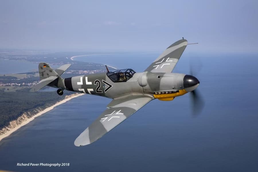 A Messerschmitt Bf 109 flying over the coast.
