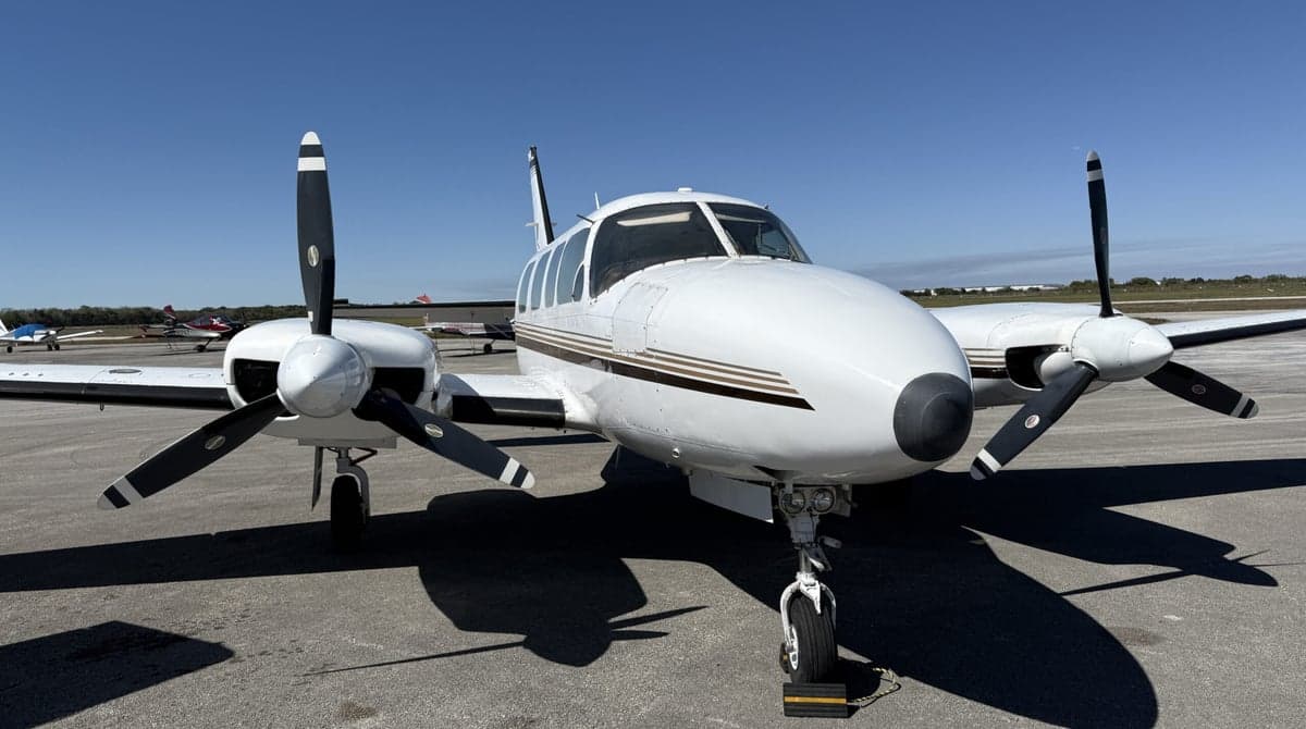 Close-up front view of the twin-engine aircraft N114SA on the tarmac.