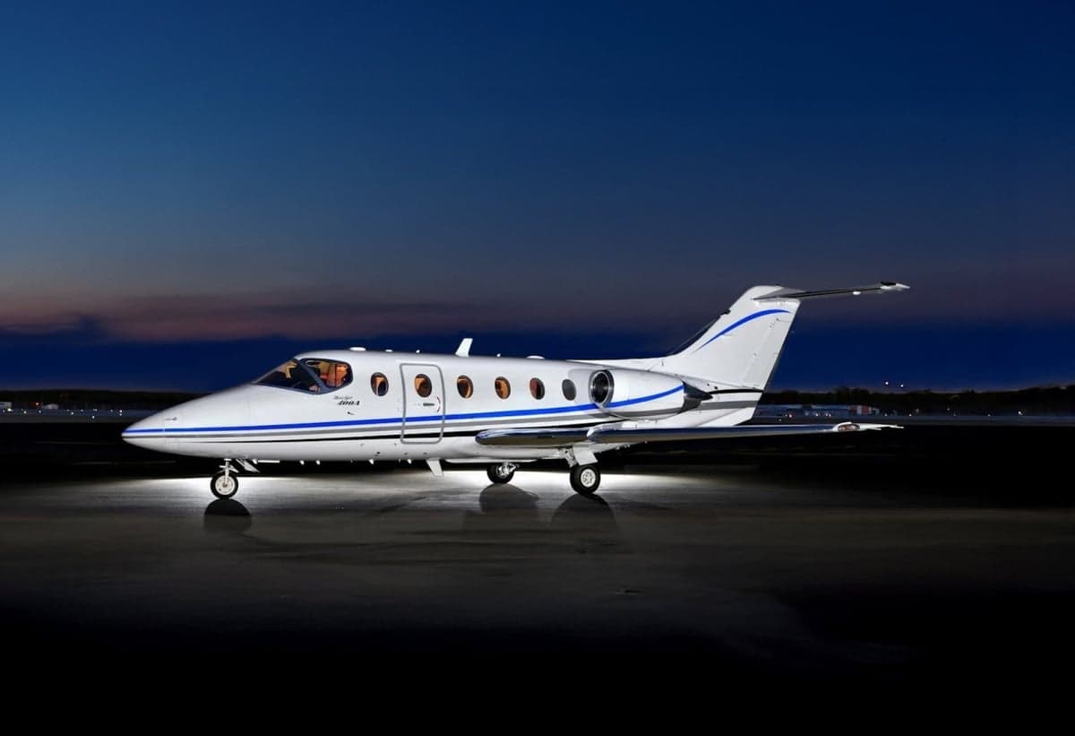 Stock photo of a Beechjet 400A on the tarmac at dusk.