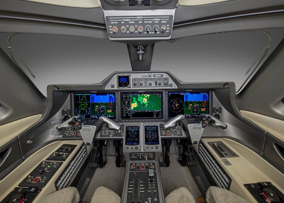 The cockpit of the aircraft, featuring multiple screens and controls.