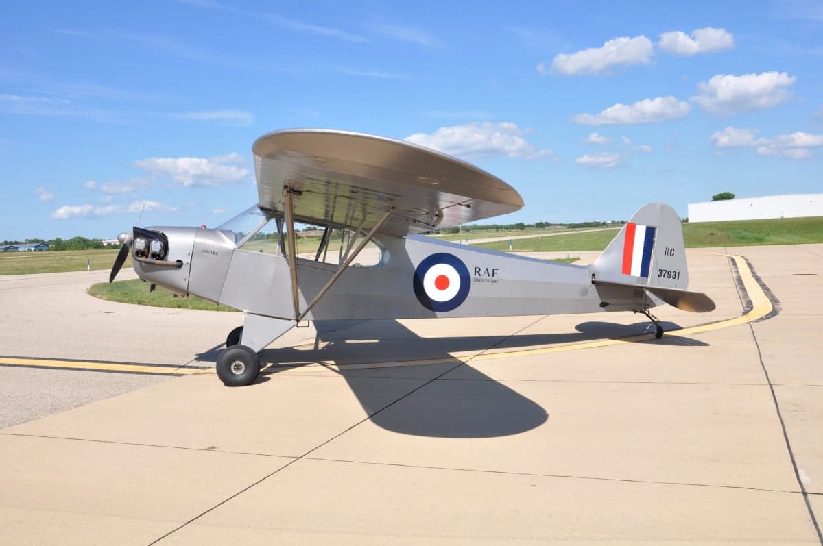 A silver Flitfire Indiana aircraft is parked on the tarmac.