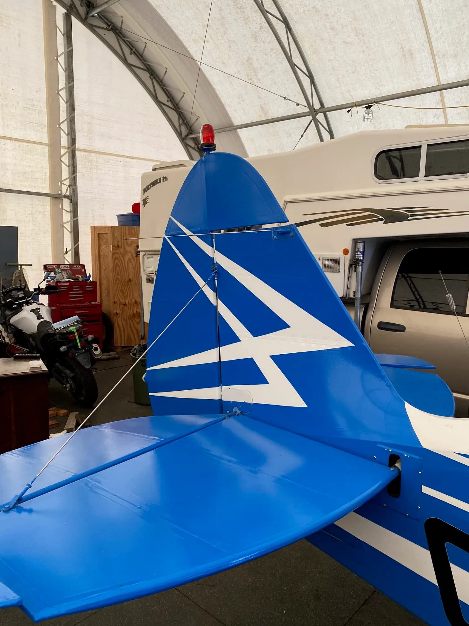Close up of the tail of the blue and white Piper Tri-Pacer aircraft.