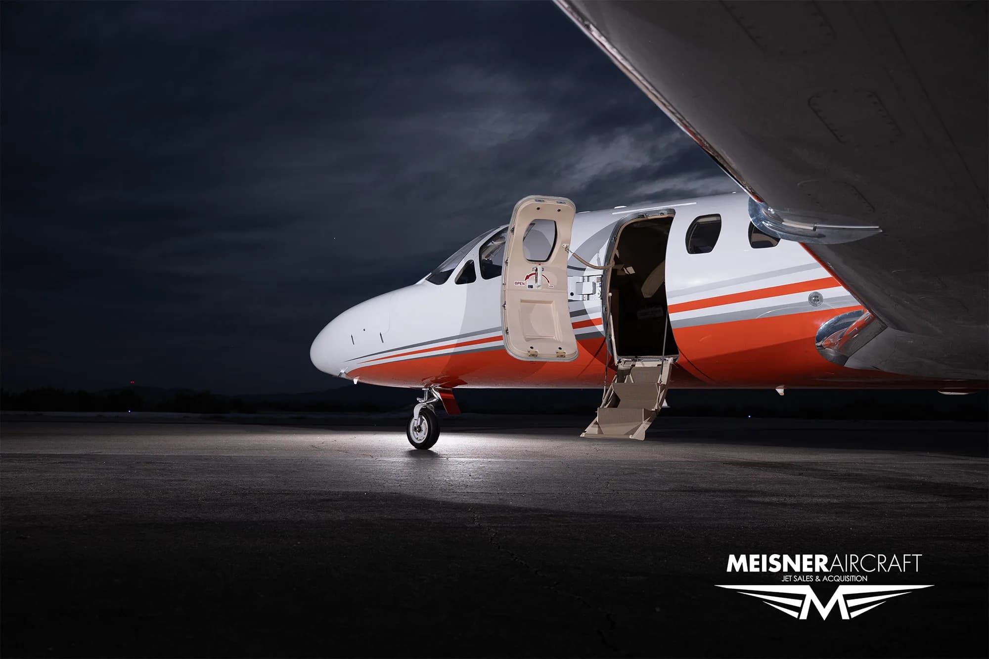 Cessna Citation Encore with open door at dusk.