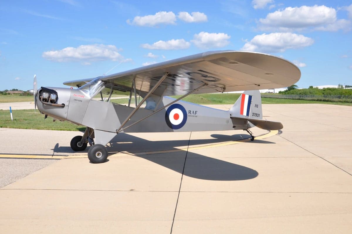 A silver Flitfire Indiana aircraft is parked on the tarmac.