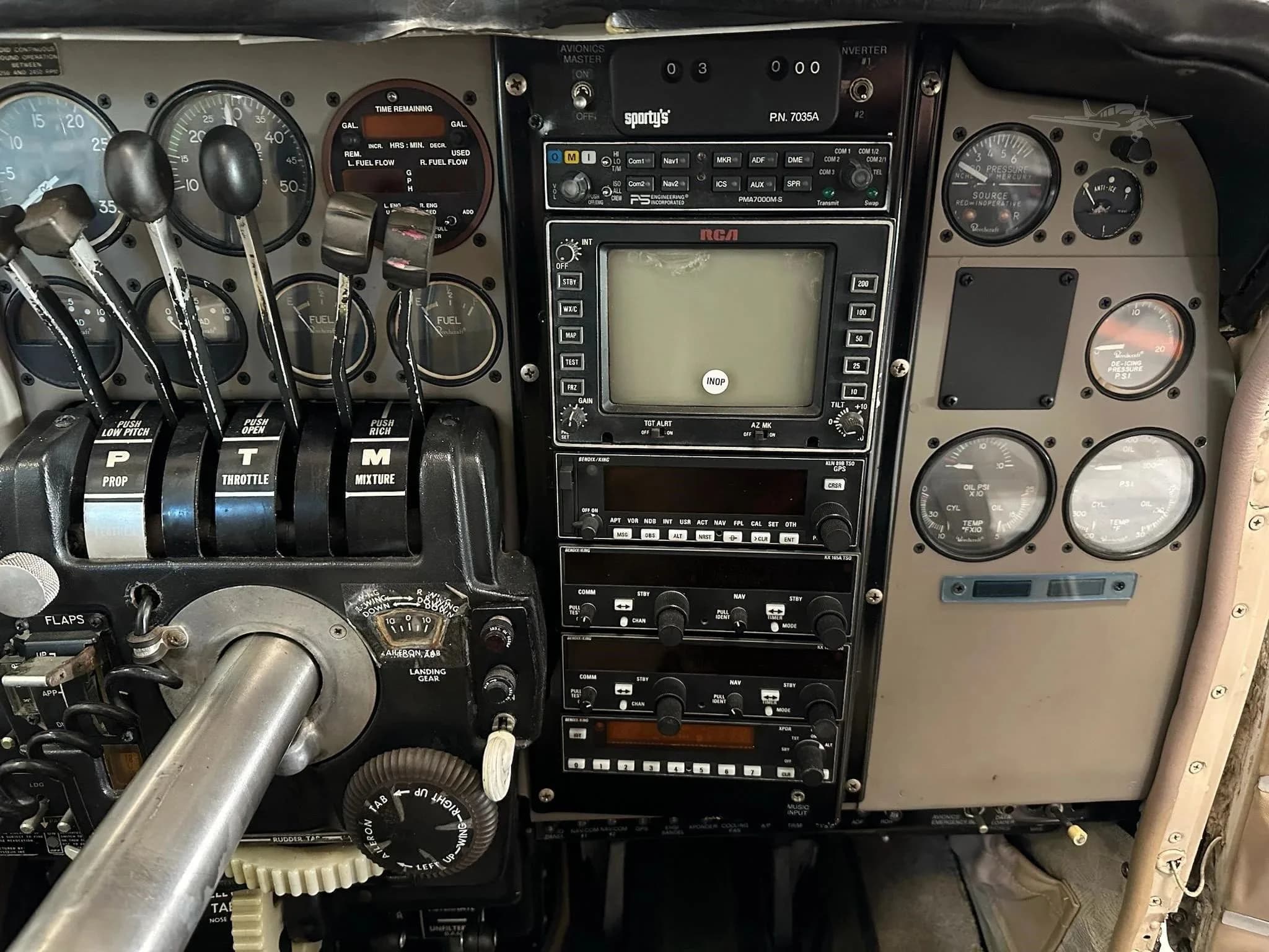A close-up of the central avionics stack and engine controls in the aircraft's cockpit.