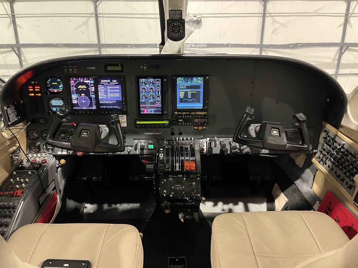 The cockpit of the aircraft features a full instrument panel and dual control wheels.