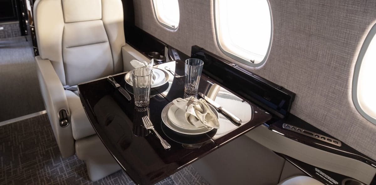 Close-up of a table set for dining inside the aircraft cabin.