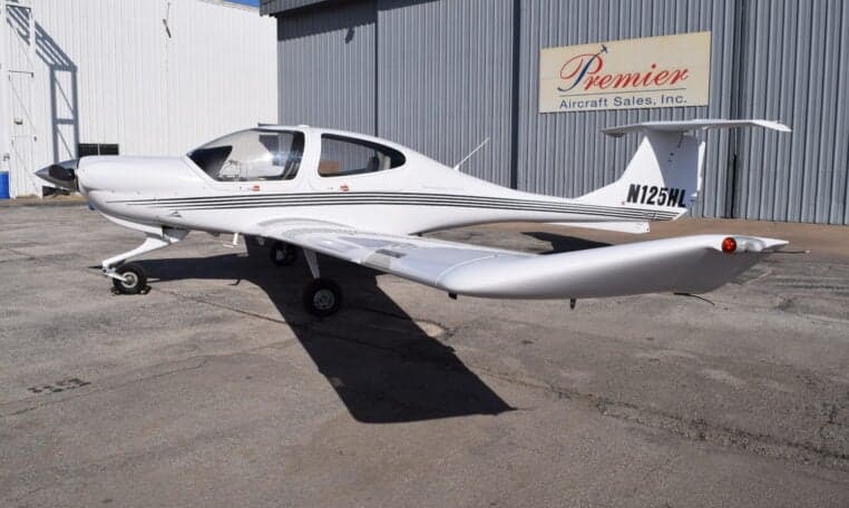Side view of a Diamond DA40 aircraft with registration N125HL parked on the tarmac.
