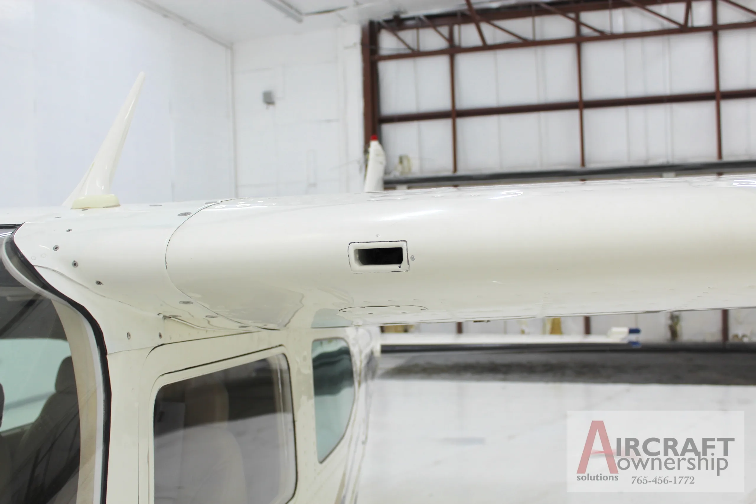Close-up view of the top of the fuselage and wing root of the Cessna 206 aircraft, N5091V.