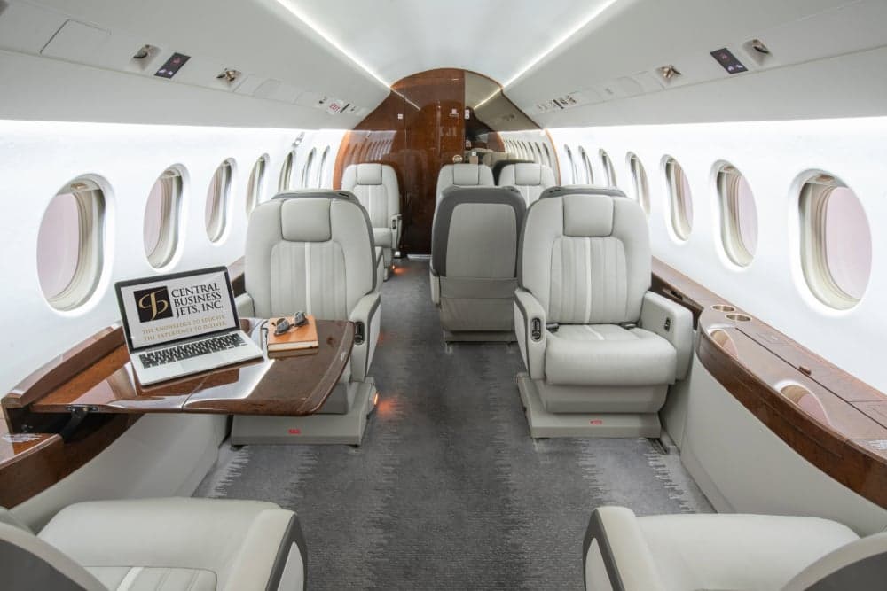 View of the aircraft interior with a laptop on the table.