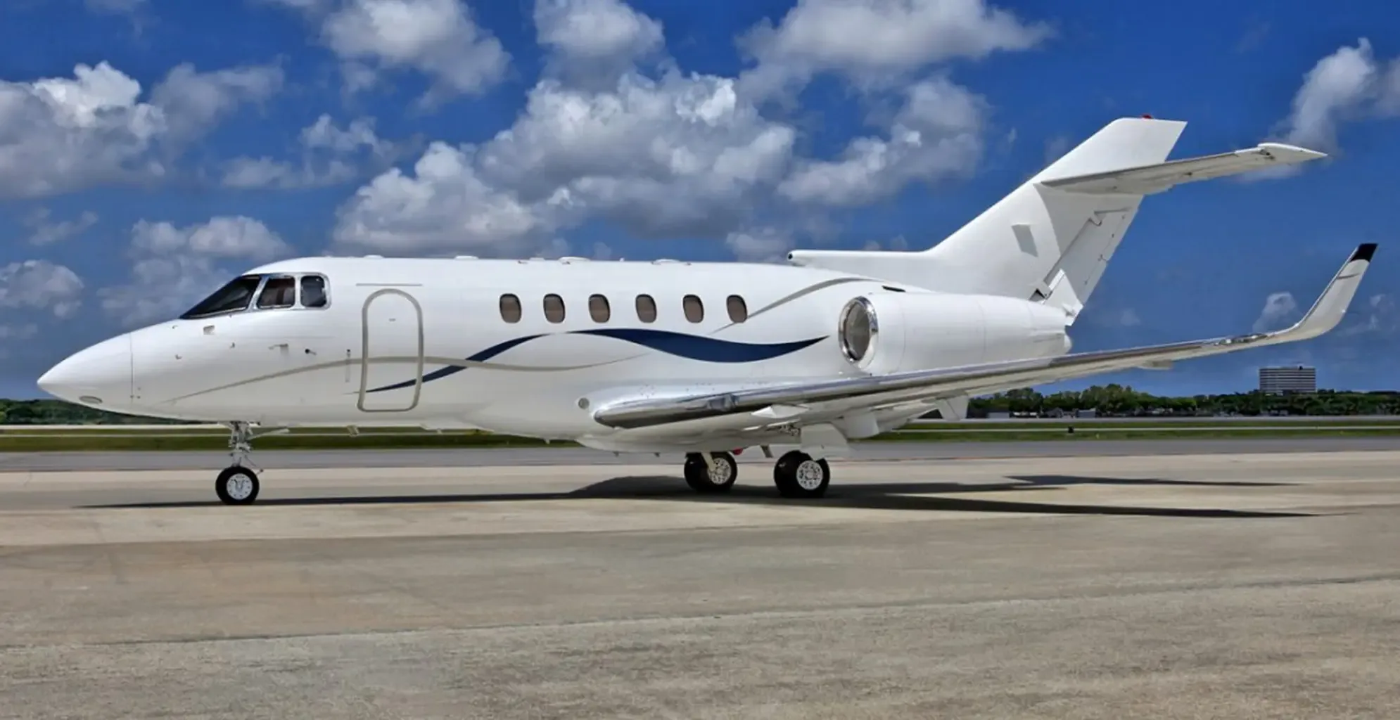 Side view of a white Dassault Falcon on the tarmac.