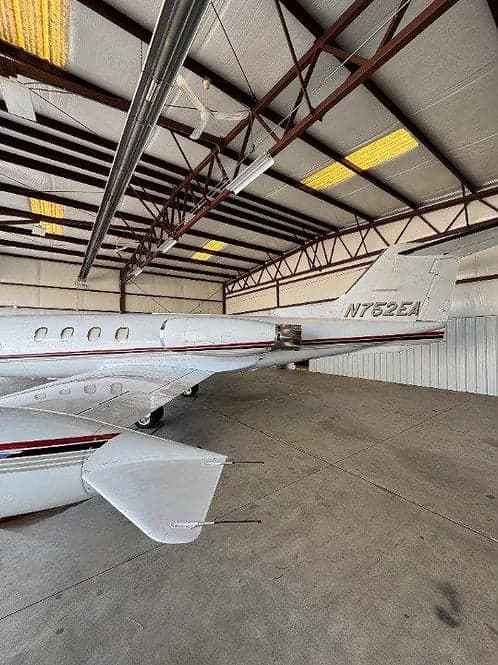 Tail section of a Learjet 35A with tail number N752EA in a hangar.