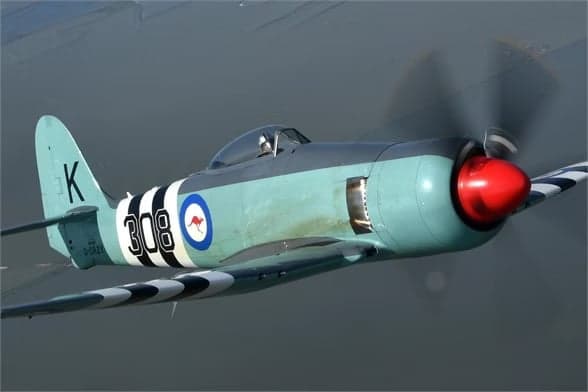 Hawker Sea Fury in flight with grey and green paint scheme.