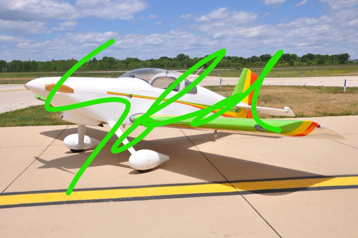 Side view of a white and colorful experimental aircraft with "SOLD" overlaid.