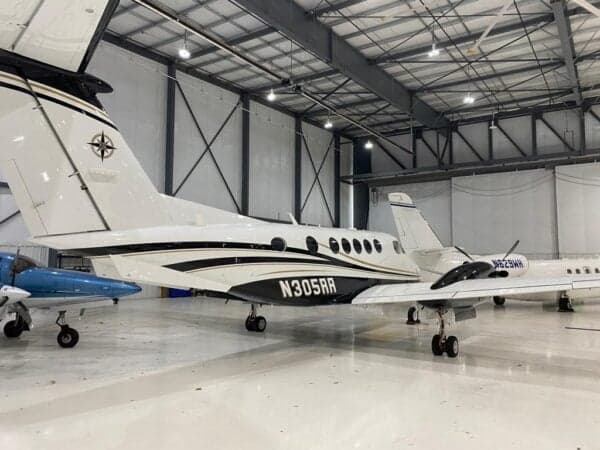 Beechcraft King Air 350 in a hangar, showing the tail number N305RR.