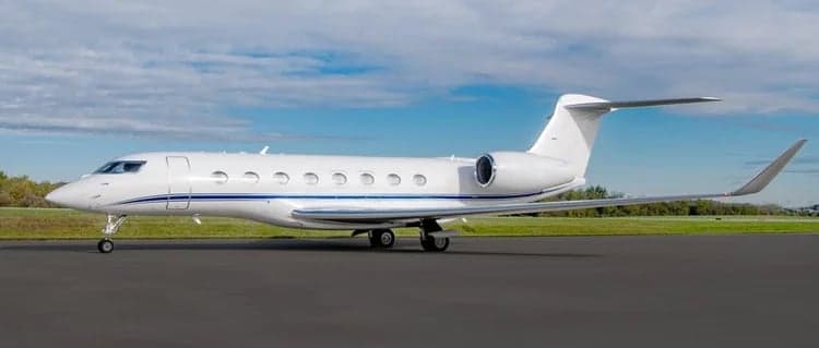 A white Gulfstream G550 parked on the tarmac.
