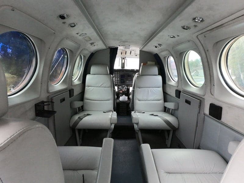 A view of the Beechcraft King Air 90C's cabin, showcasing the seating arrangement and interior design.