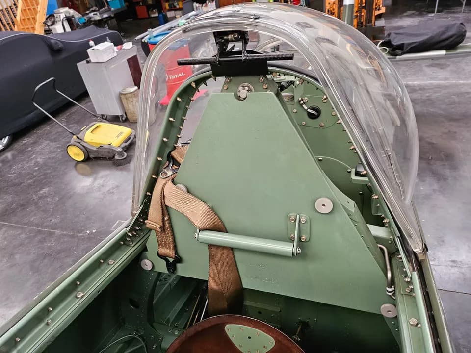 An interior view of the Supermarine Spitfire cockpit, looking towards the rear, showing the canopy and internal structure.