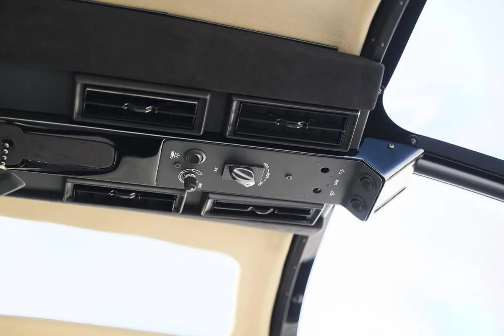 An overhead view of a helicopter's interior showing air vents and control switches.