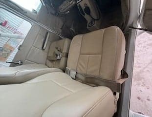 Beige interior of a Cessna 172 with seats and seatbelts.