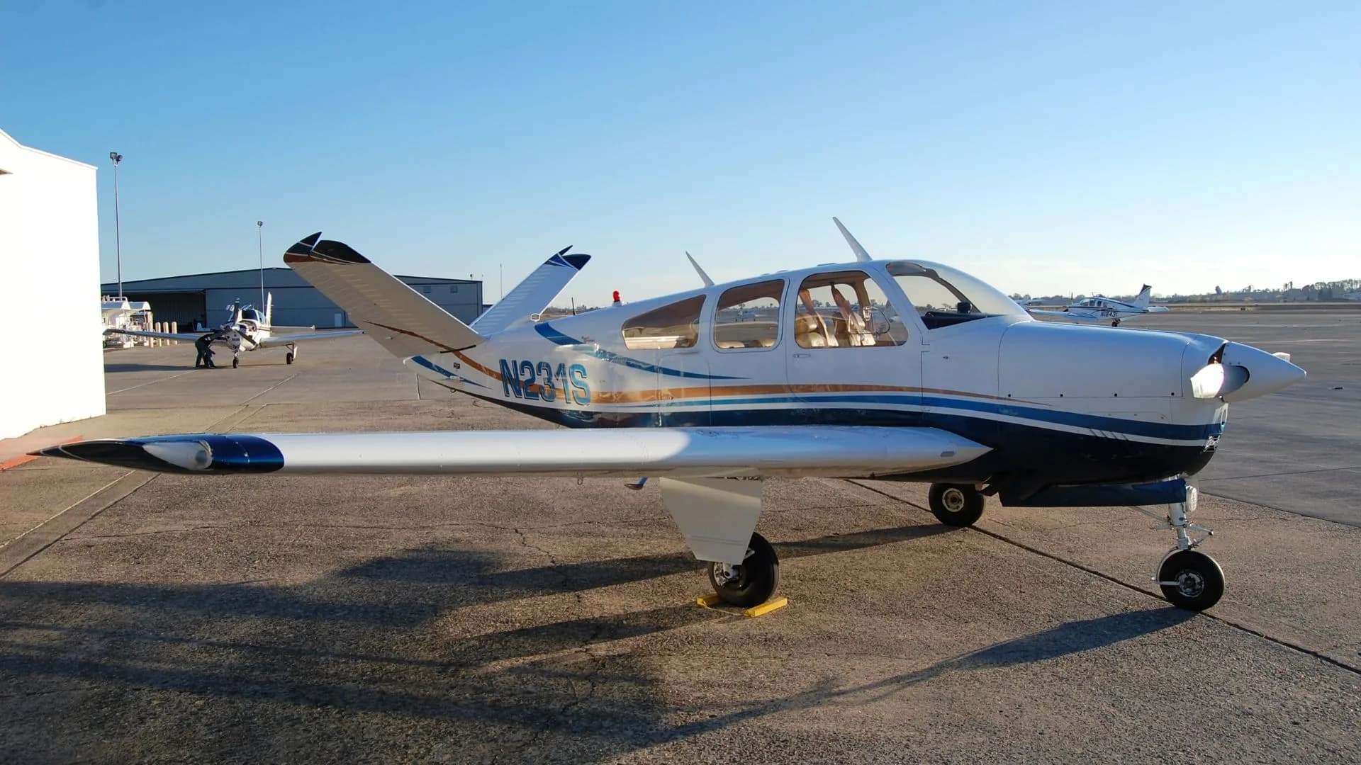 Side view of the N231S aircraft parked on the tarmac.