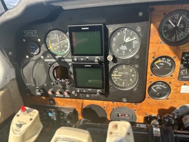 Close-up of the aircraft's instrument panel with Garmin displays.