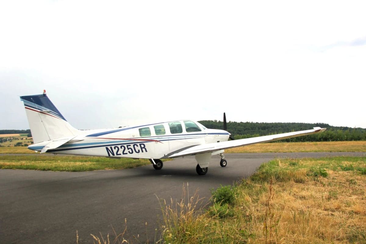 N225CR Beechcraft Bonanza parked on the tarmac, side view.