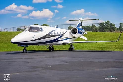 A Learjet 45XR, registration N156DH, parked on the tarmac.