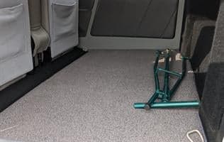The interior of the aircraft shows the rear seats with seatbelts.