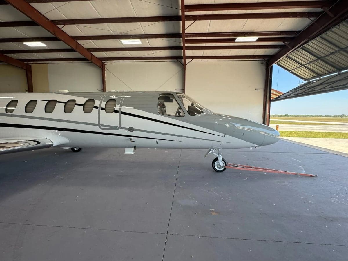 Close-up side view of a Cessna Citation CJ3, registration N858RM, inside a hangar.