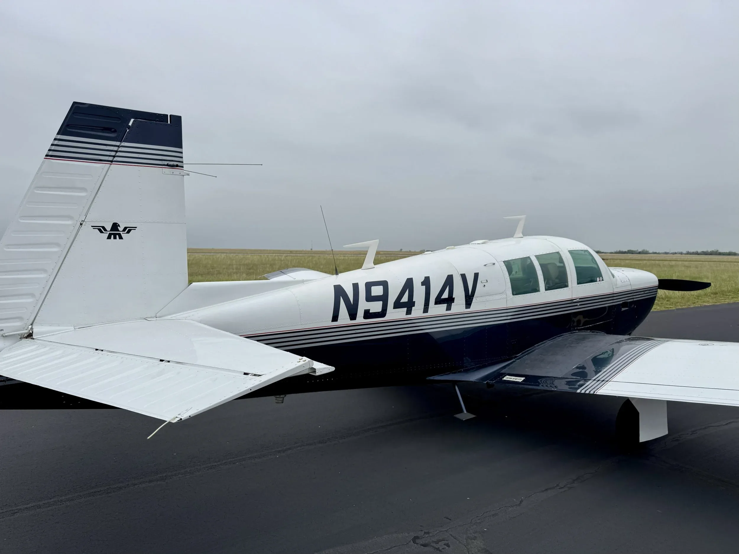 A Beechcraft Bonanza aircraft with registration N9414V is parked on the tarmac.