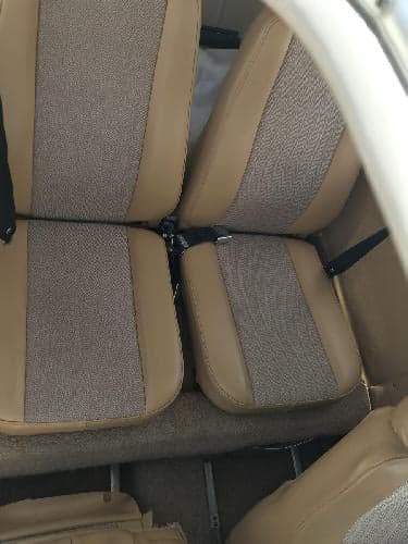 Close-up of the aircraft's tan and gray fabric seats.
