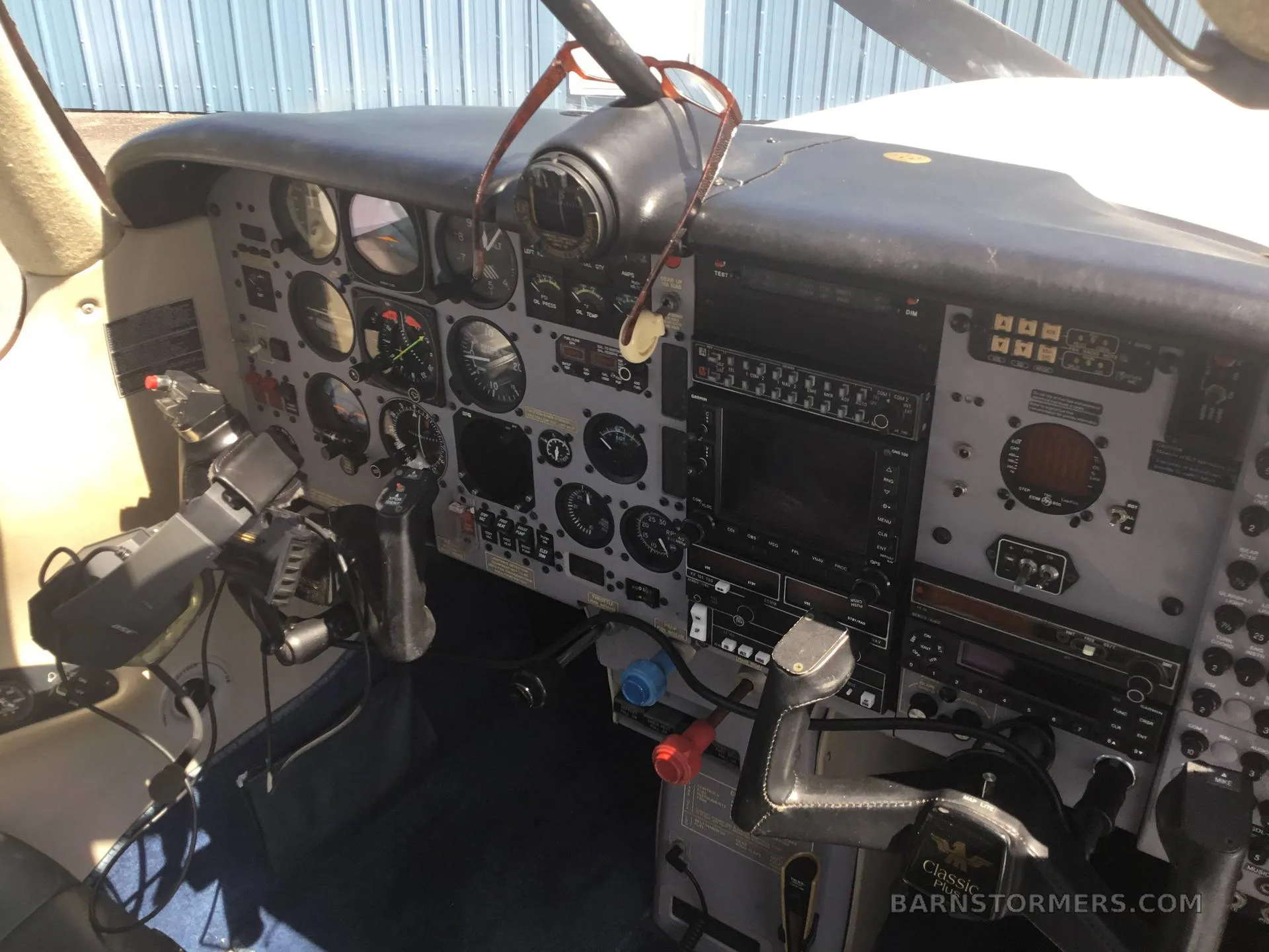 The cockpit instrument panel of a small aircraft, featuring various gauges, screens, and controls.