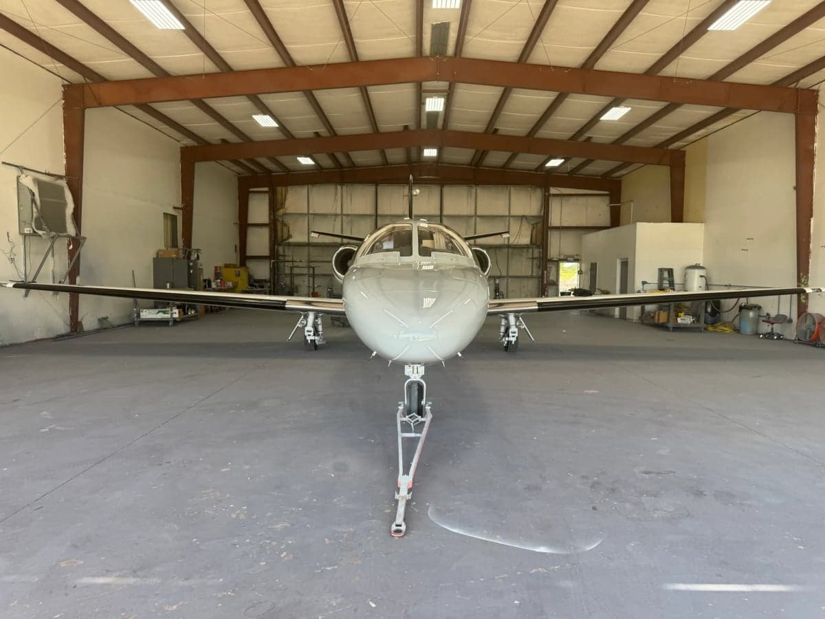 Front view of a Cessna Citation CJ3, registration N858RM, inside a hangar.