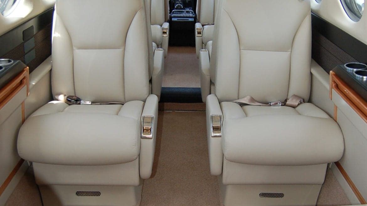 Close-up of the aircraft's cabin seats with beige leather.