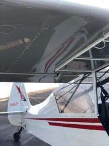 Close-up of the aircraft's tail and wing, showing the registration number.
