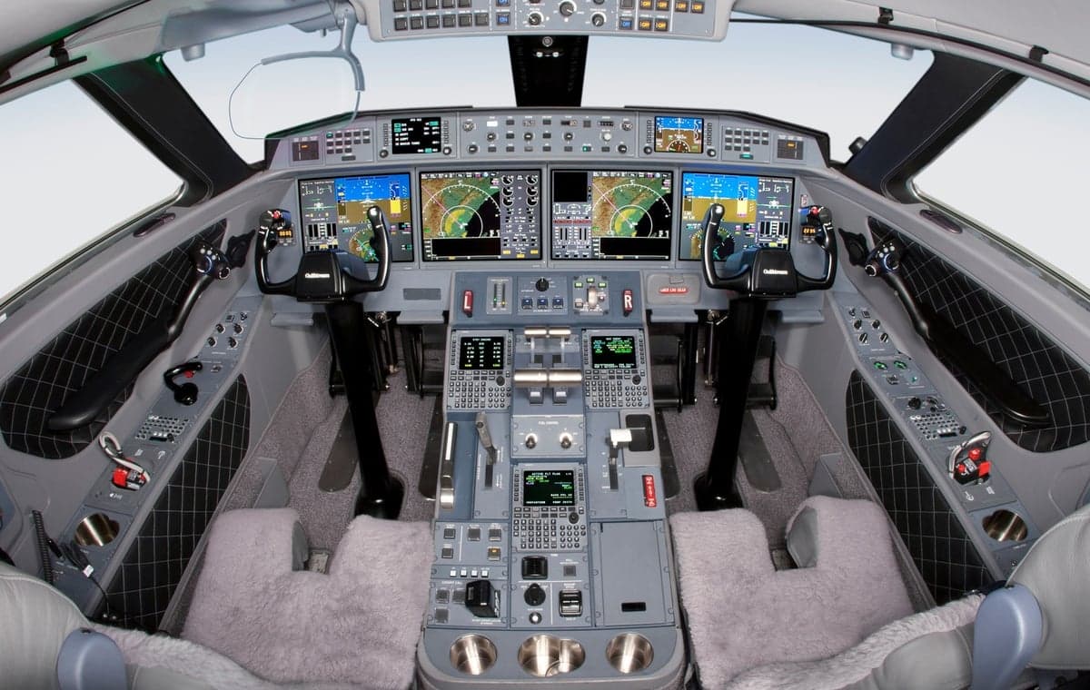 Aircraft cockpit with instrument panel and controls.