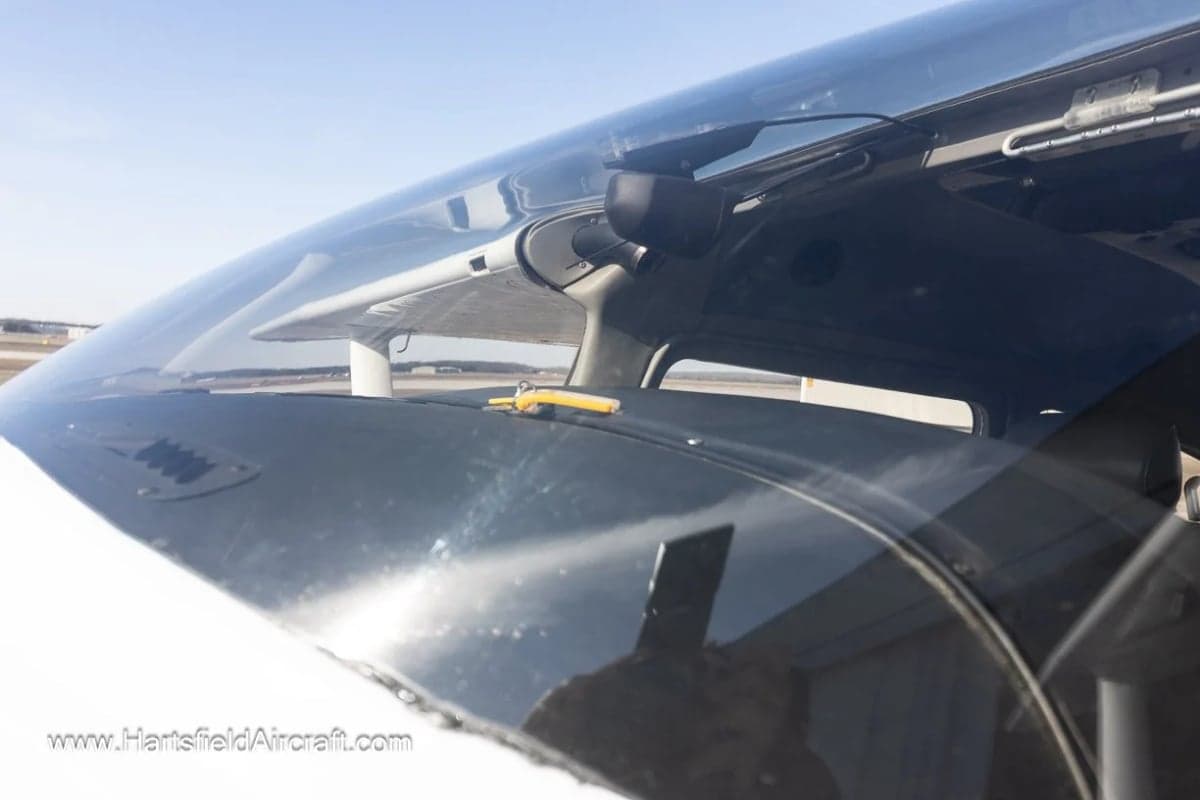 View of the cockpit windshield and dashboard of an aircraft.