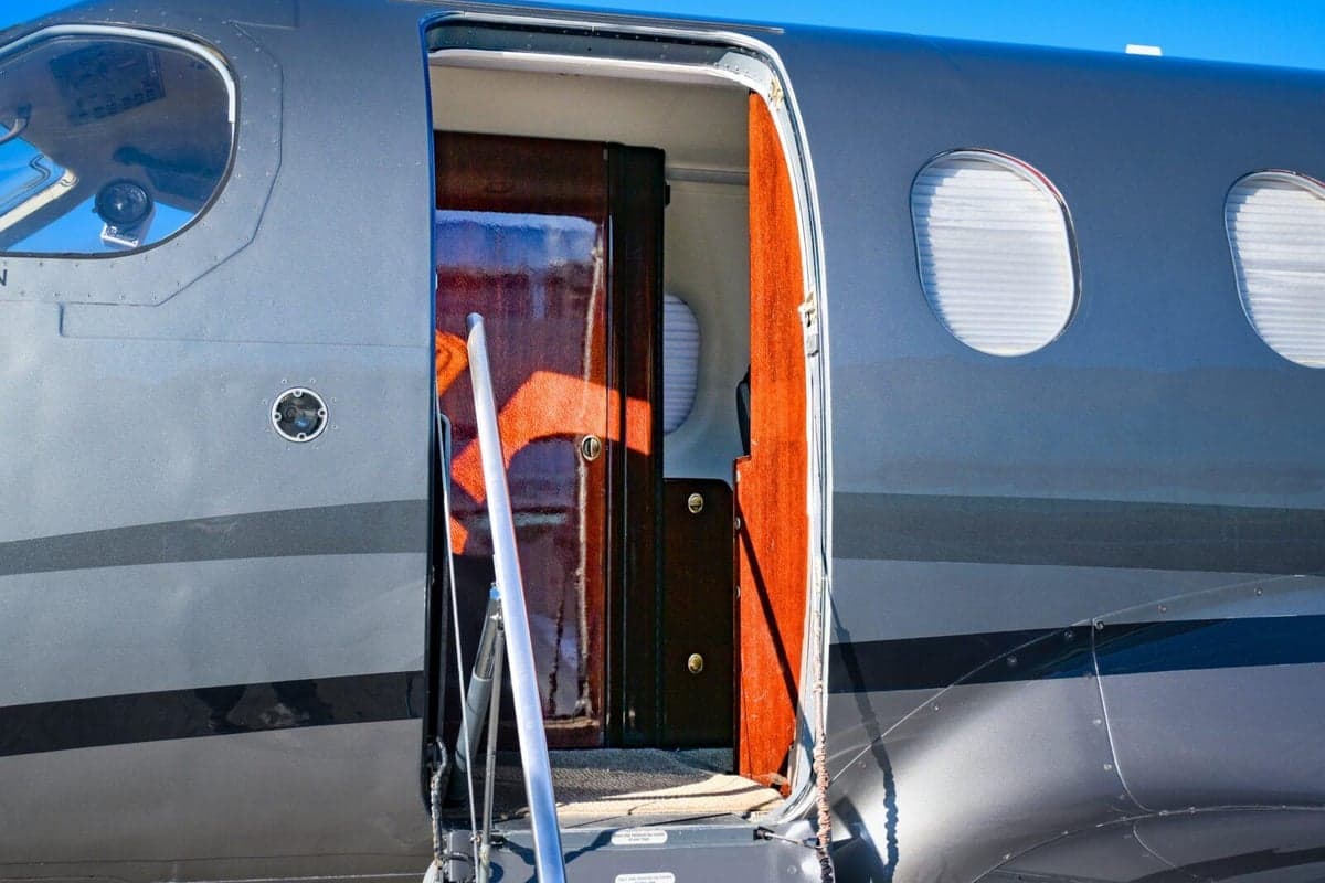 Close-up of the open door of the Pilatus PC-12 aircraft.