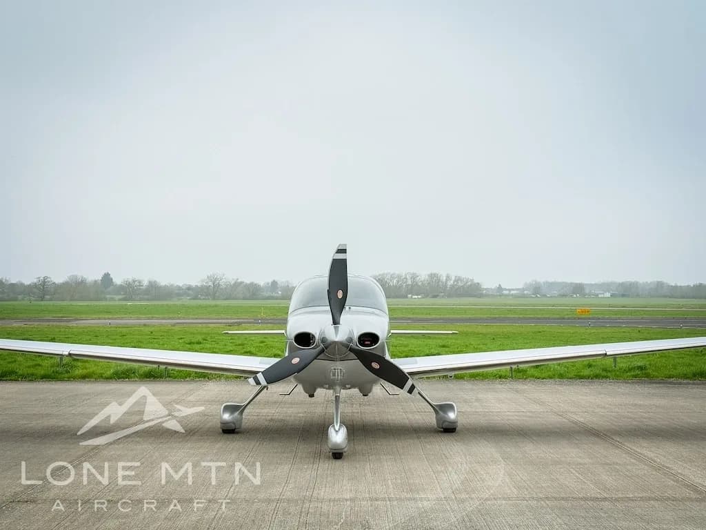 Front view of a silver Cirrus SR22 aircraft, registration N6918C, parked on an airfield.