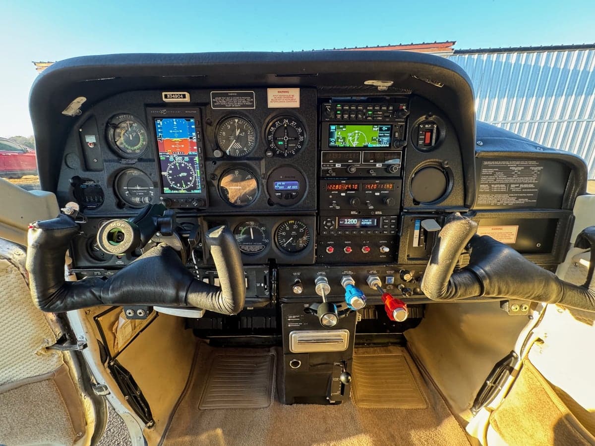 The cockpit of the Cessna Cardinal features a full instrument panel and control yokes.